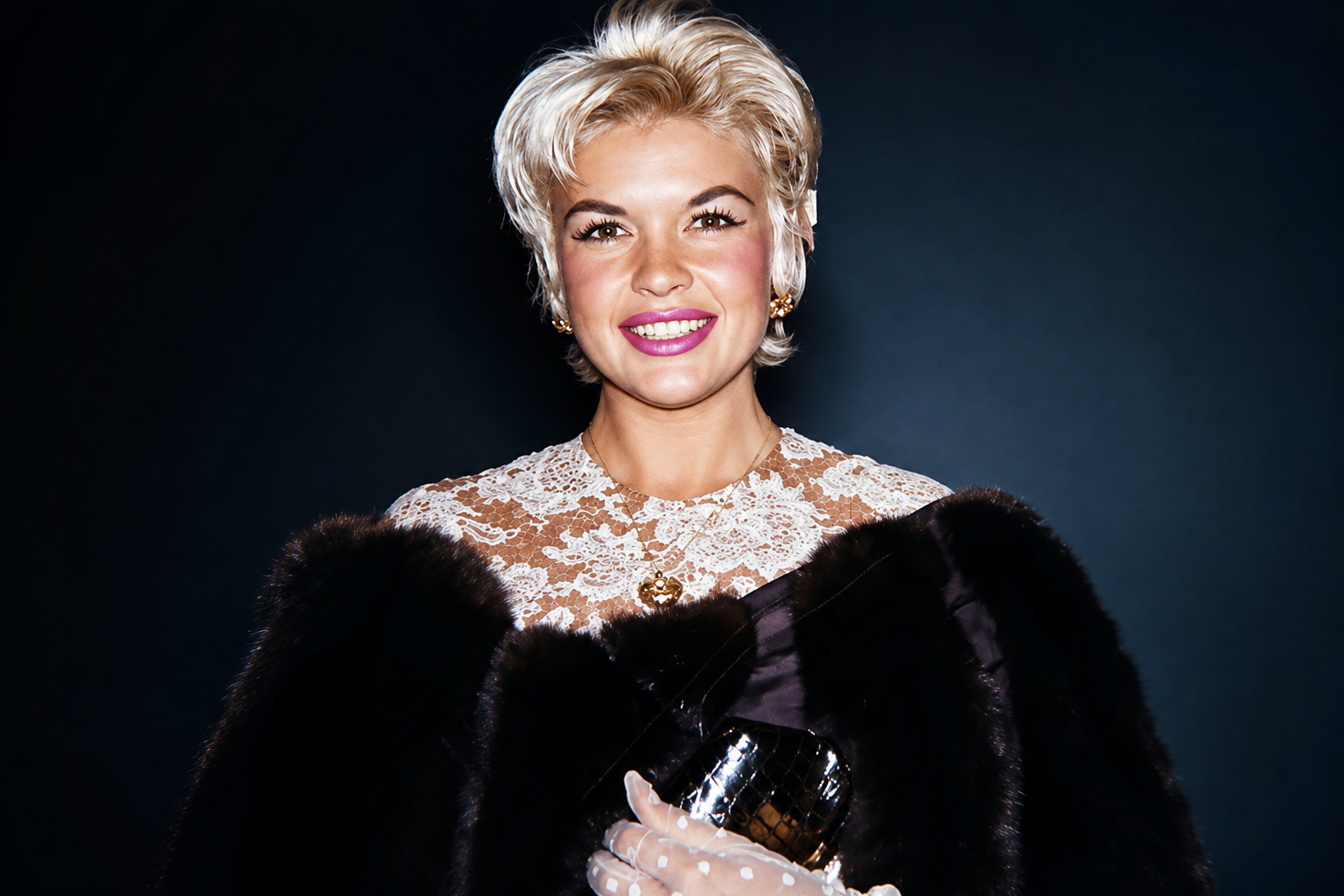 Jayne Mansfield smiling in a vintage Hollywood portrait wearing a lace dress and fur wrap