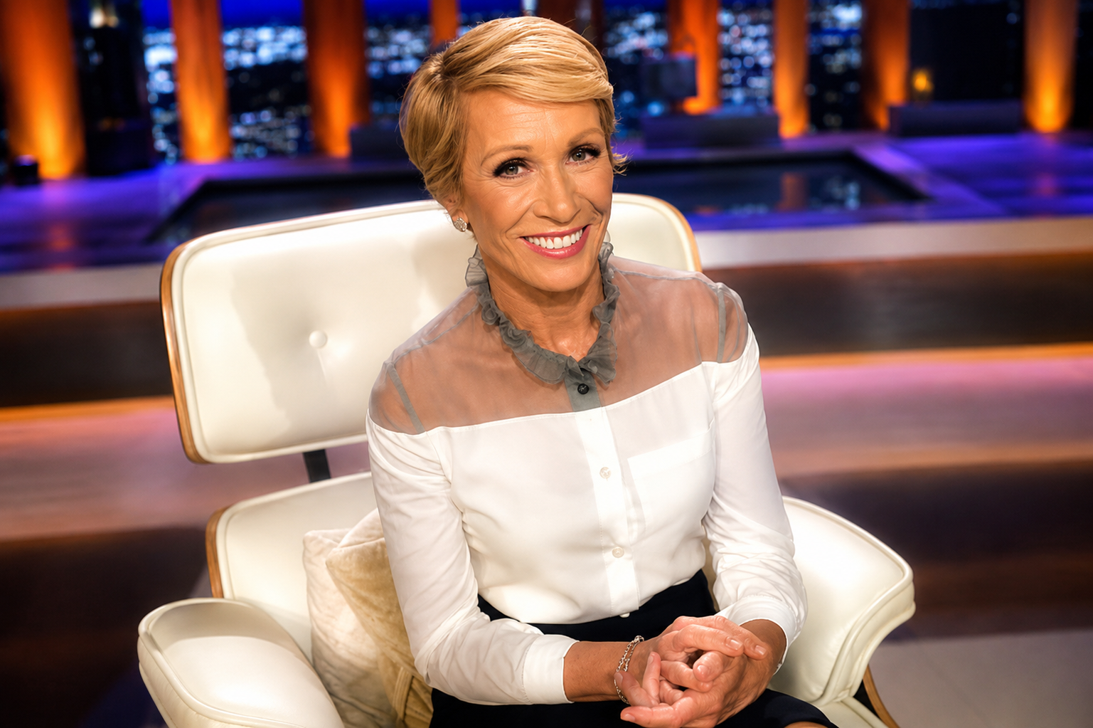 Barbara Corcoran smiling while seated in a television studio