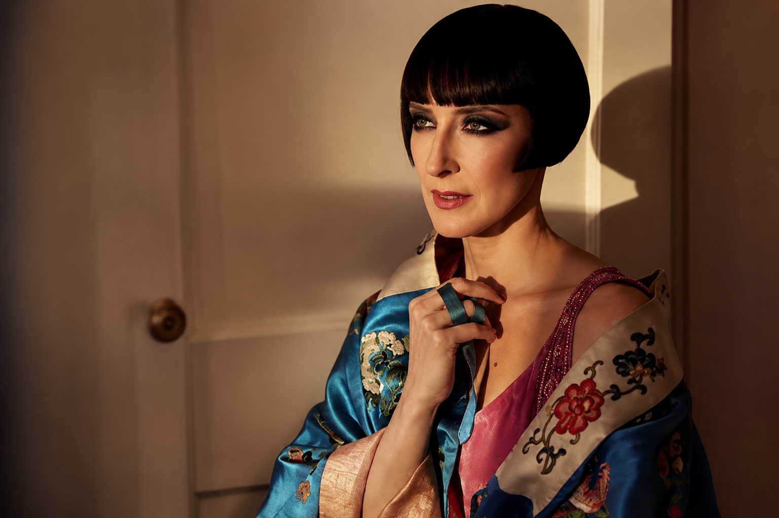 Dr. Colleen Darnell posing in a colorful embroidered robe