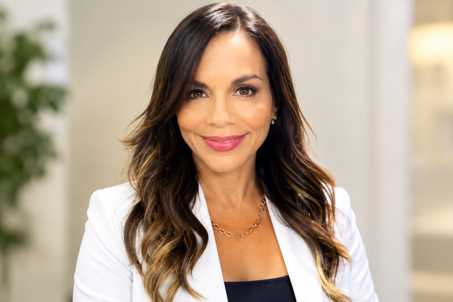 Caridad Rivera net worth 2026 – smiling in a white blazer