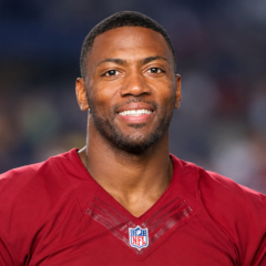 Ryan Clark net worth 2026 – wearing a football jersey and smiling at the camera