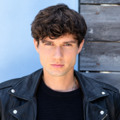 Zach Justice net worth 2026 – posing in a black leather jacket