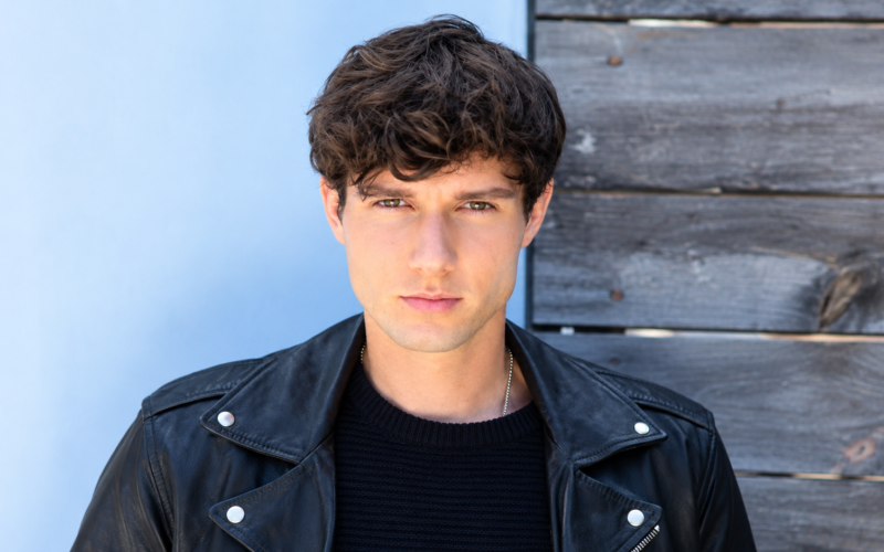 Zach Justice net worth 2026 – posing in a black leather jacket