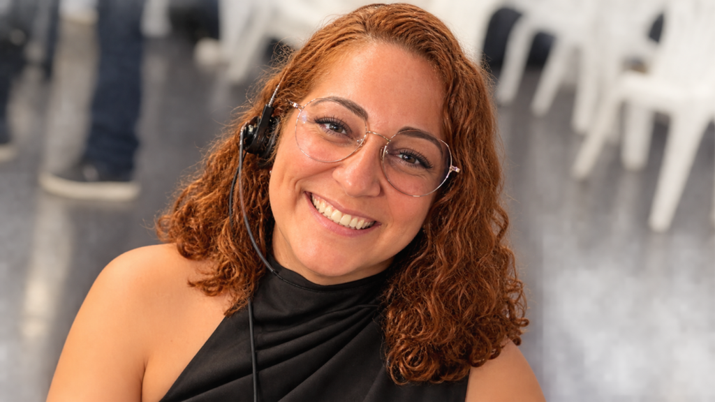Lysaurie Ocasio net worth 2026 – smiling and wearing glasses at an indoor event