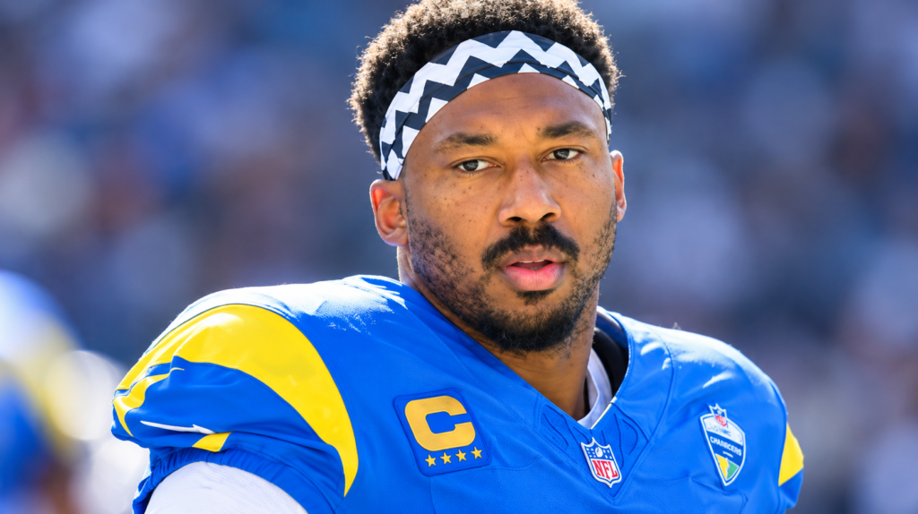 Myles Garrett net worth 2026 – wearing a blue and yellow football jersey and headband