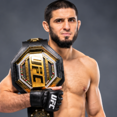 Islam Makhachev net worth 2026 – posing with a UFC championship belt