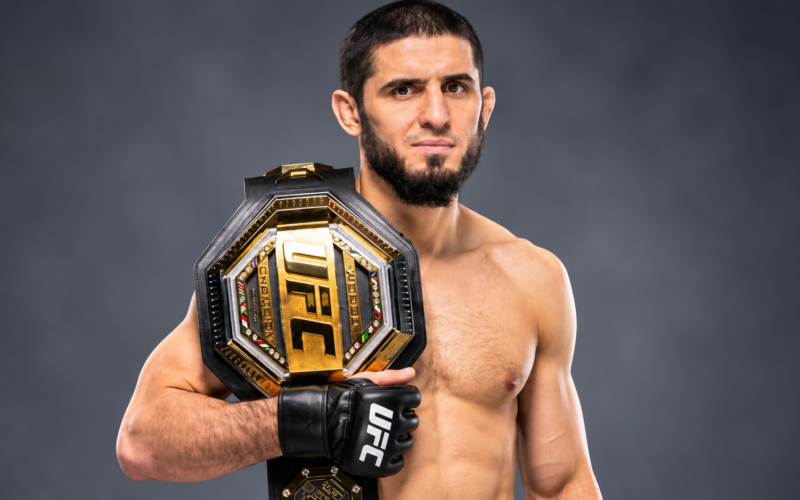 Islam Makhachev net worth 2026 – posing with a UFC championship belt