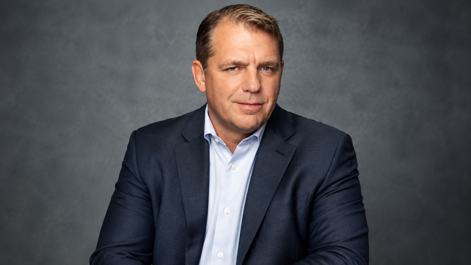 Todd Boehly net worth 2026 – wearing a navy blue suit and light blue shirt