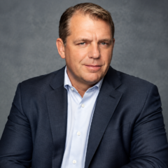 Todd Boehly net worth 2026 – wearing a navy blue suit and light blue shirt