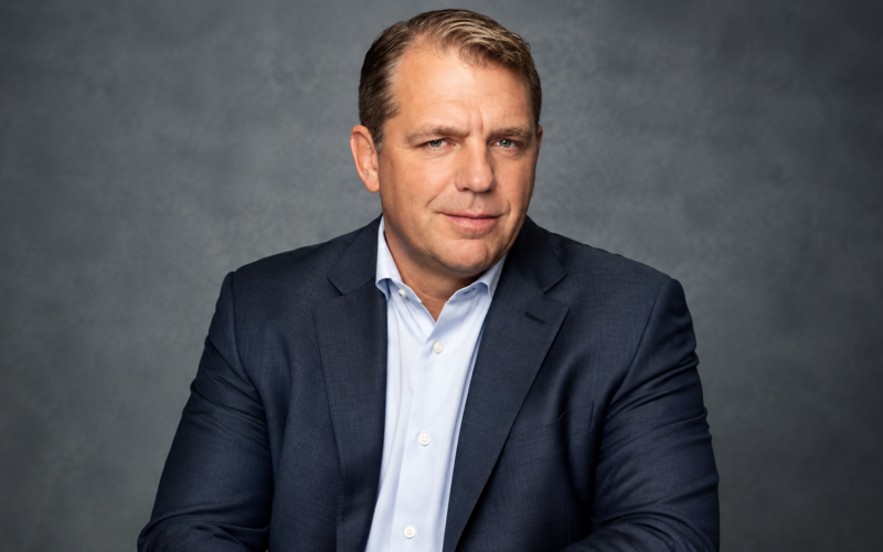 Todd Boehly net worth 2026 – wearing a navy blue suit and light blue shirt