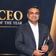 Neal Mohan holding an award at a CEO of the Year event