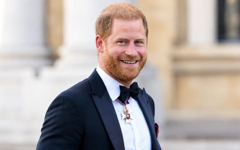Prince Harry wearing a black tuxedo and bow tie with a medal