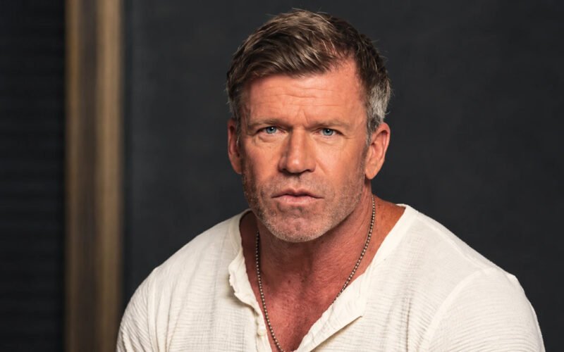 Taylor Sheridan posing in a white shirt for a portrait