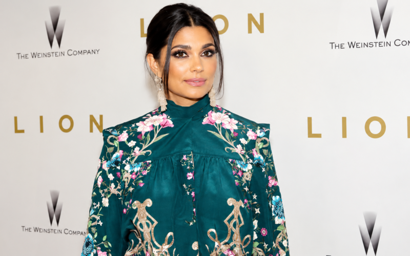 Rachel Roy wearing a floral embroidered teal outfit at a red carpet event