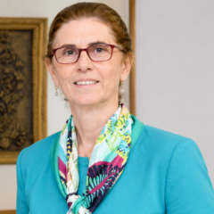 Annie Pardo Cemo wearing a teal blazer and colorful scarf
