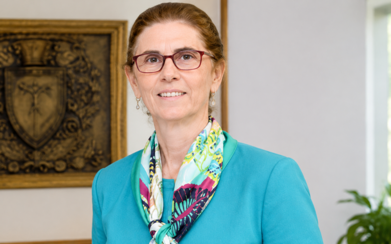 Annie Pardo Cemo wearing a teal blazer and colorful scarf