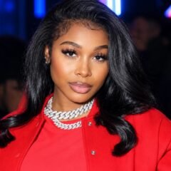 Jayda Wayda wearing a red outfit and layered chain necklaces