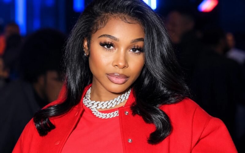 Jayda Wayda wearing a red outfit and layered chain necklaces