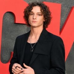 Mason Thames posing in a black outfit at a Netflix event