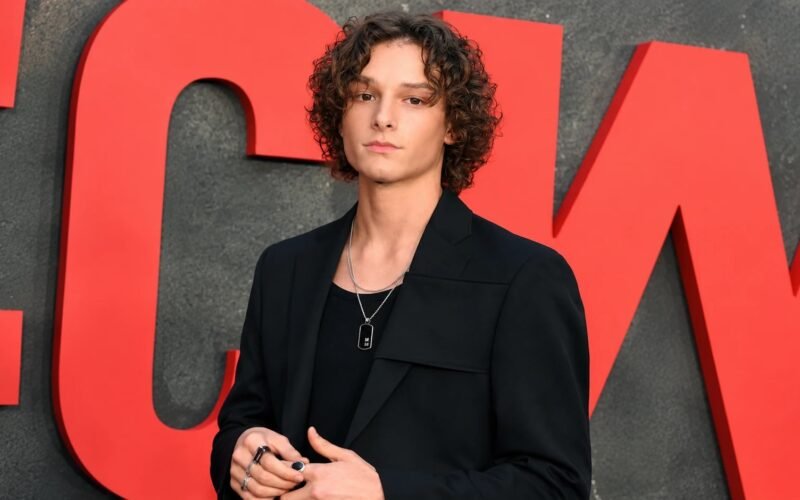 Mason Thames posing in a black outfit at a Netflix event